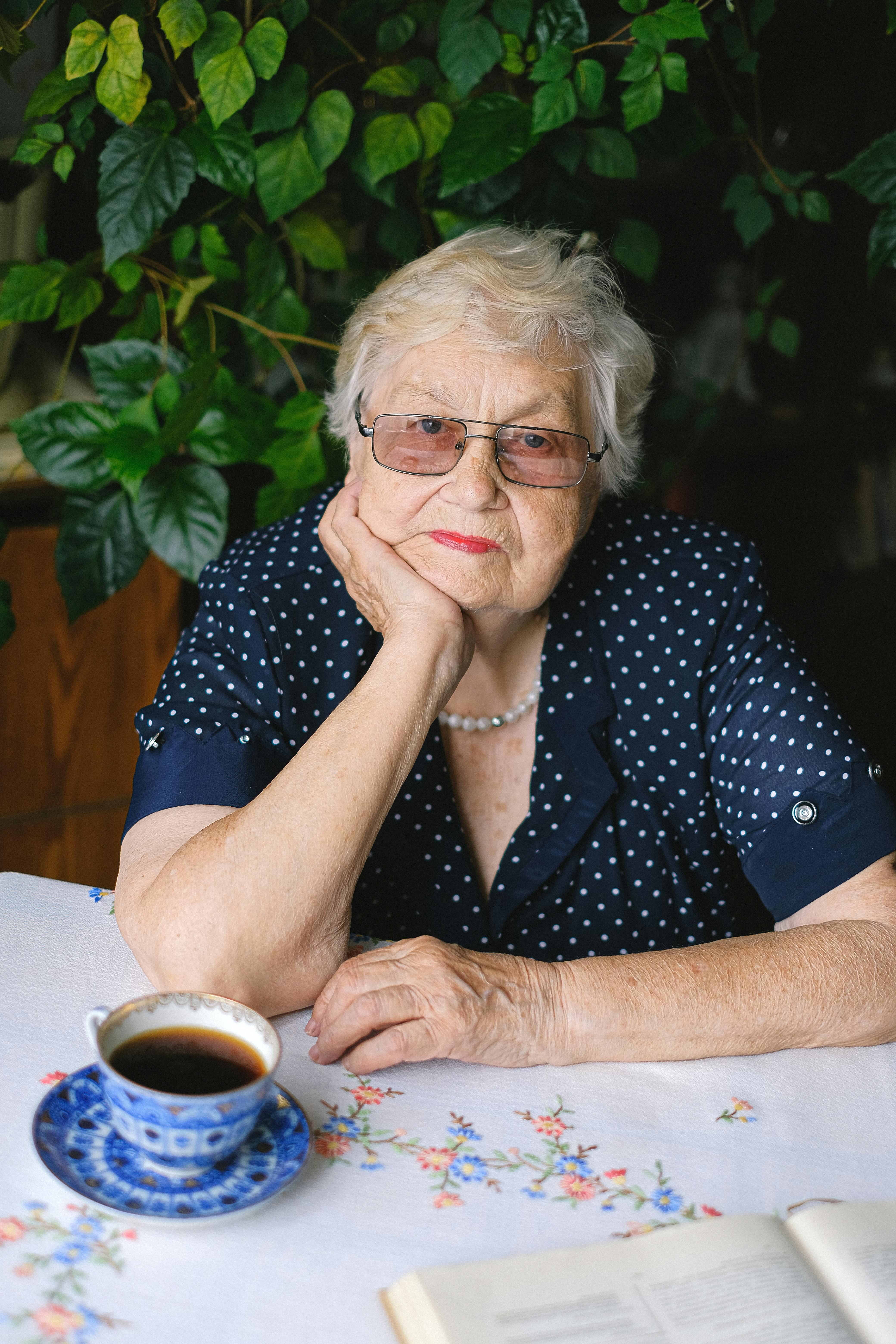 senior woman sitting at table in room