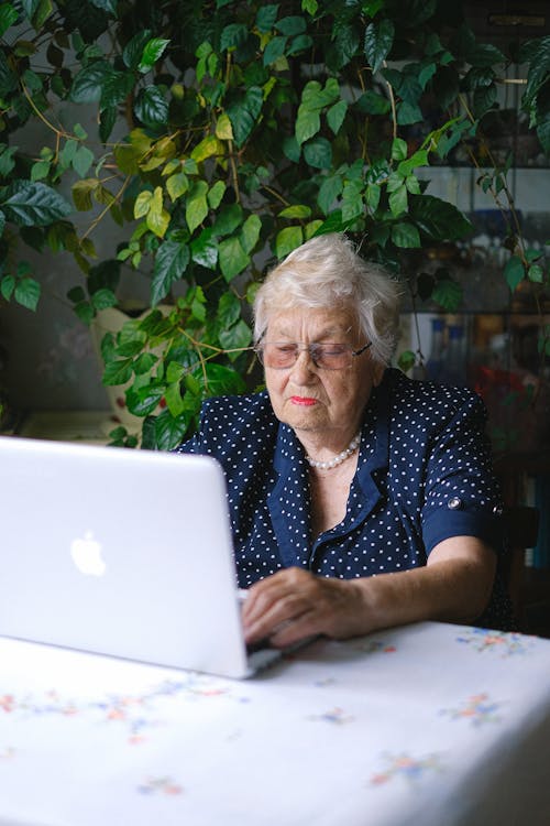 A Woman Using a Silver Colored Laptop