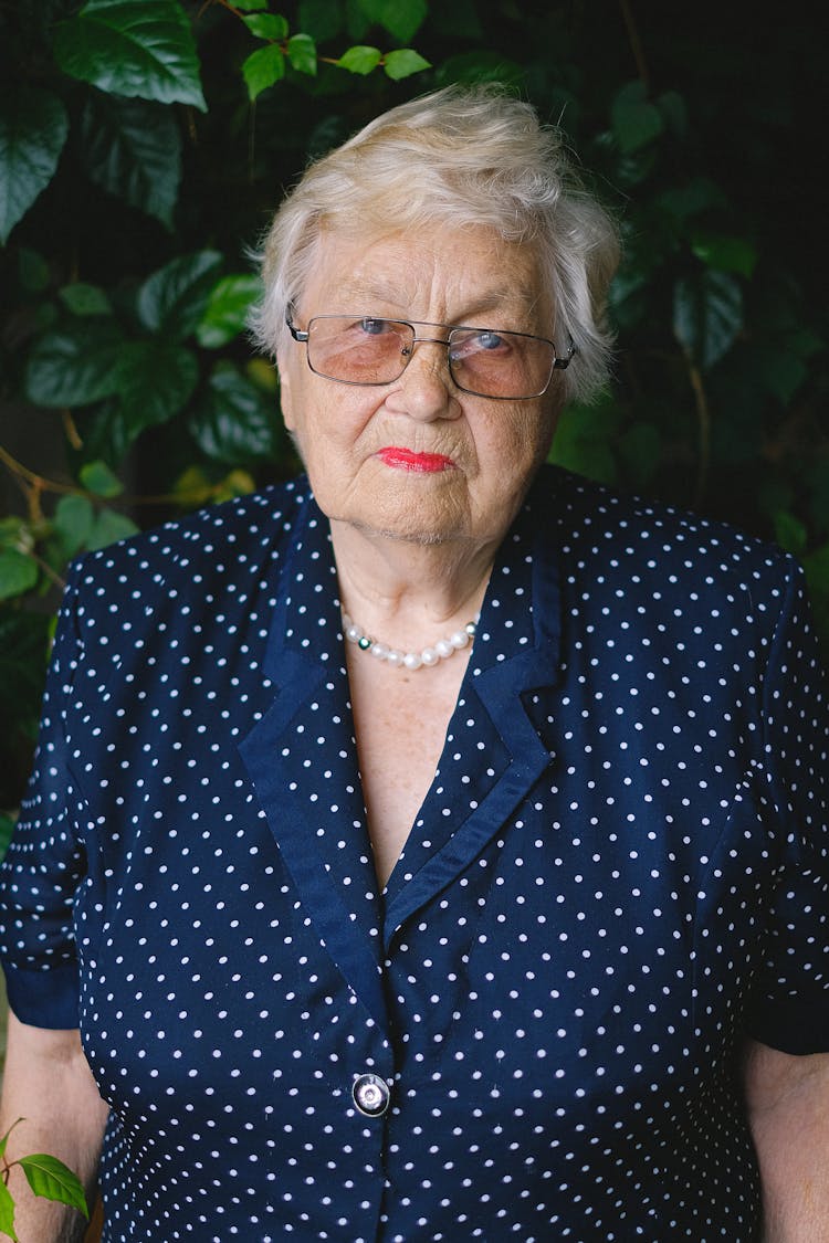 Aged Woman In Eyeglasses And Polka Dot Dress