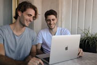 Men Using a Laptop on the Coffee Table