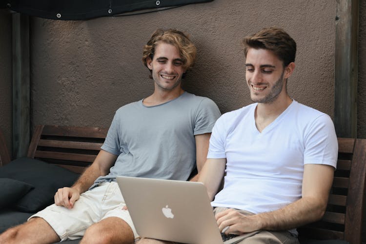 A Two Men Looking The Laptop Together 