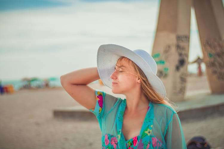 A Woman Wearing A Sunhat In The Beach