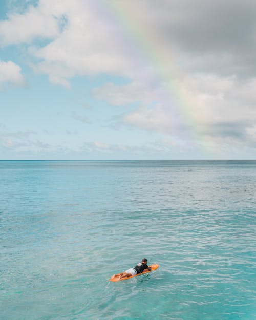 A Man Surfing on Sea