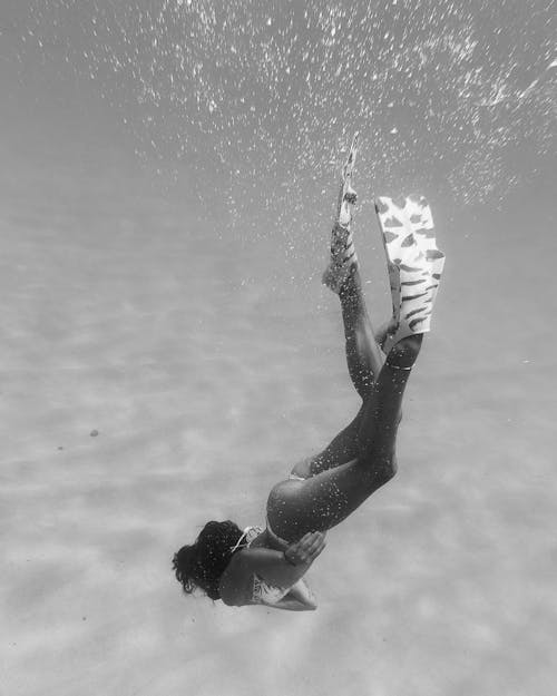 A Woman in Bikini Swimming 