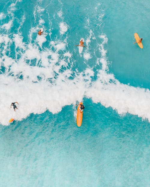 Free Aerial View of People Surfing on Sea Waves Stock Photo