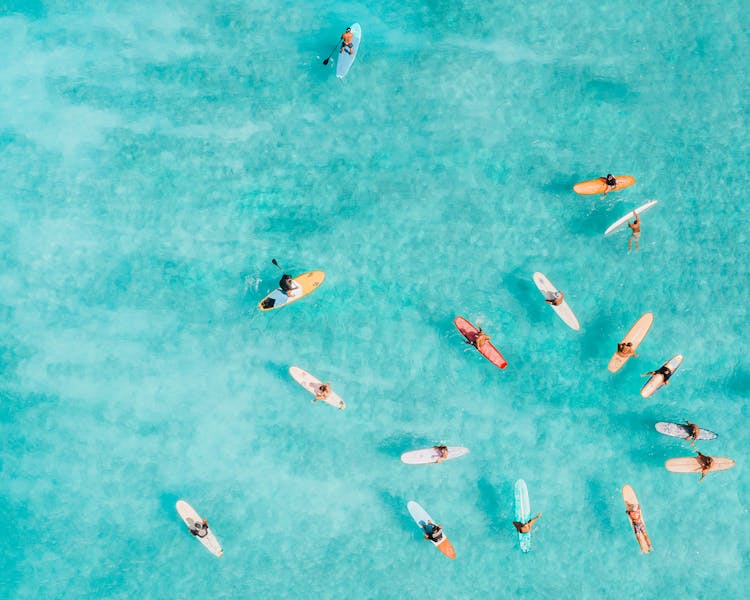 Group Of Surfers Gathered On Sea