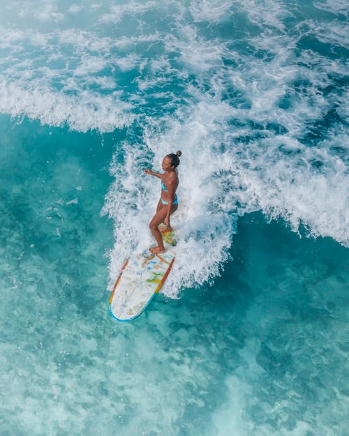 Woman Surfing in Blue Water 