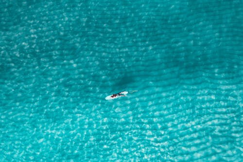 Top View of a Person on the Blue Sea