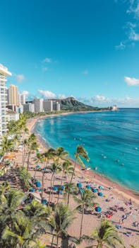 A stunning view of Waikiki Beach and Diamond Head with vibrant blue water.