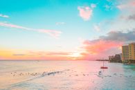 People Swimming in Sea on Sunset