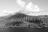Grayscale Photo of Mountain Near Body of Water