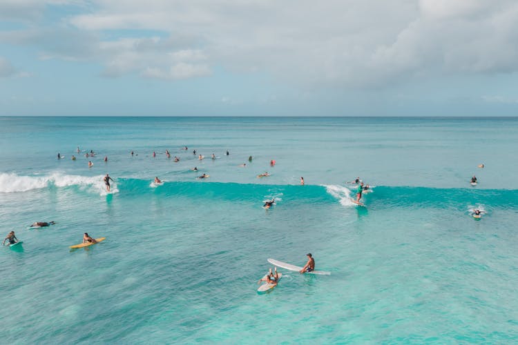 People On Boards Surfing On Ocean Waves