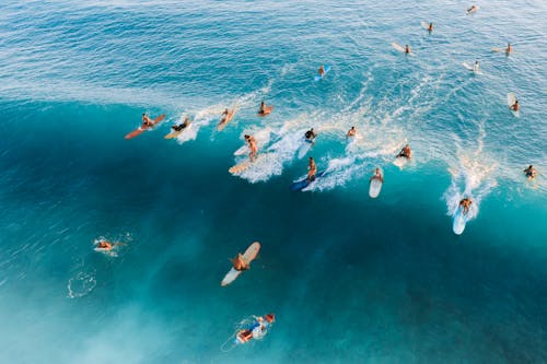 Free People Surfing on Sea Stock Photo