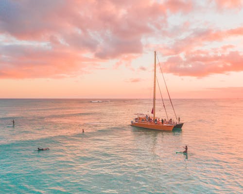 Sailboat in Sea at Pink Sunset