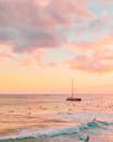 People Swimming in Ocean on Sunset