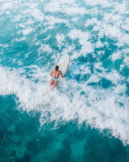 Woman Surfing on a Blue Sea