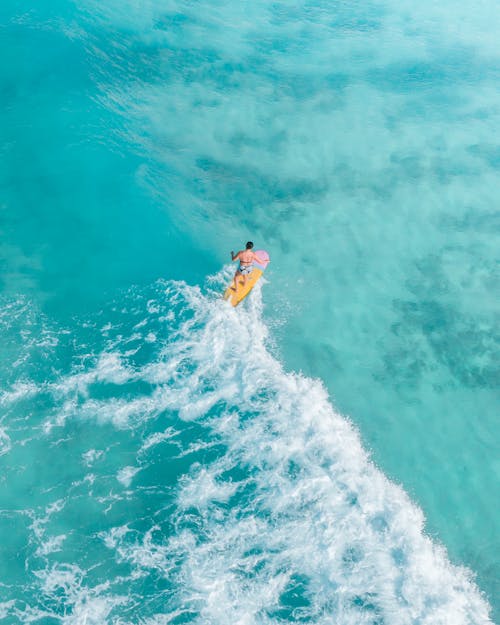 Woman Surfing on a Blue Sea