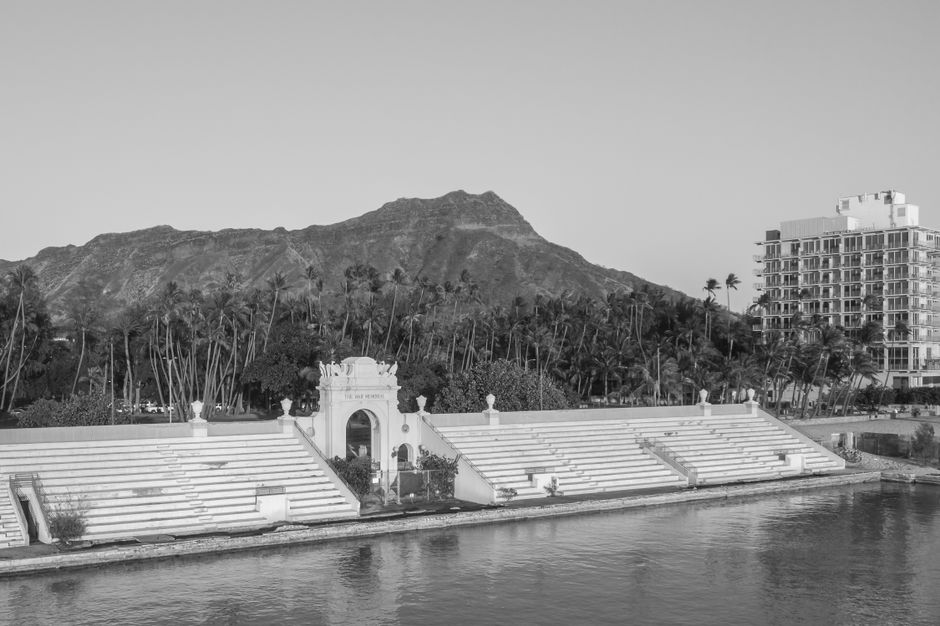 Photo by Jess Loiterton A captivating black and white photograph of Diamond Head with the War Memorial Natatorium.