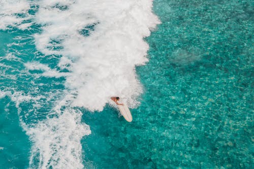 Surfer Knocked Out From the Surfboard by the Wave 