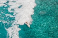 Person Surfing on Sea Waves