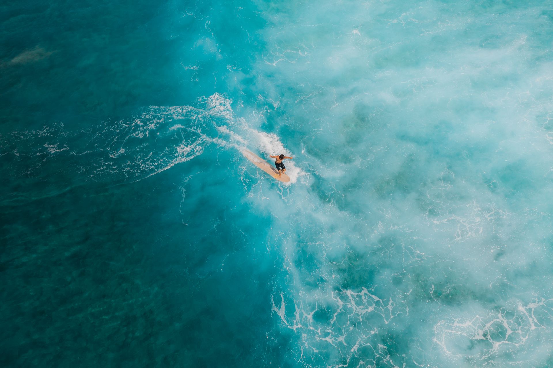 Man Surfing on Beautiful Blue Sea Water