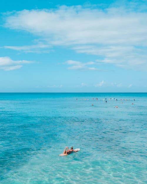 Tourists Relaxing in Sea on Paddleboard 