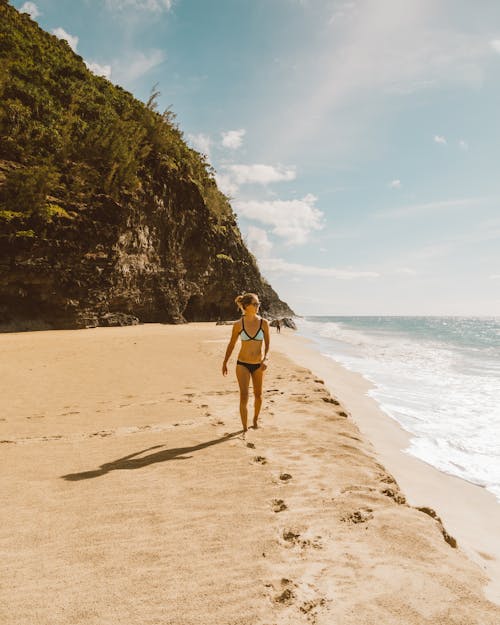 Free Woman Walking along Beach Stock Photo