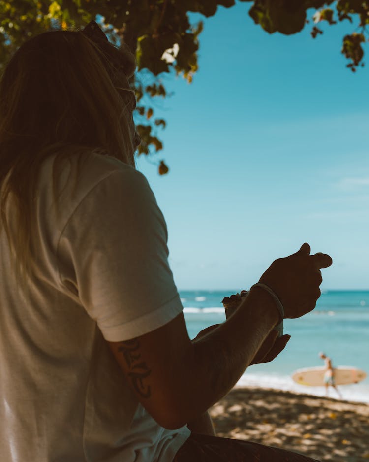 A Person Eating By The Beach