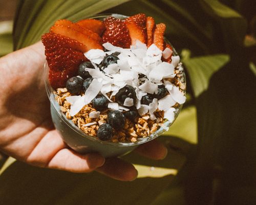 Free Vibrant acai bowl topped with strawberries, blueberries, granola, and coconut flakes. Stock Photo