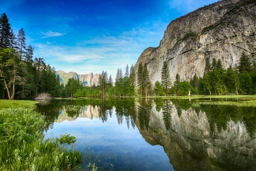 Stunning reflection of mountains and trees in Yosemite Valley's Mirror Lake during daytime.
