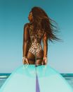 Woman in Black and White Polka Dot Bikini Standing on Pink Inflatable Pool