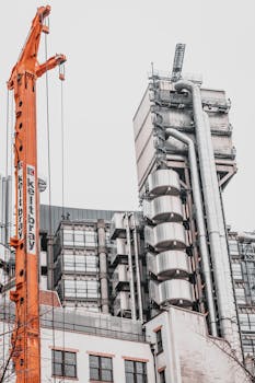 View of modern architecture with crane in London, highlighting industrial design elements.