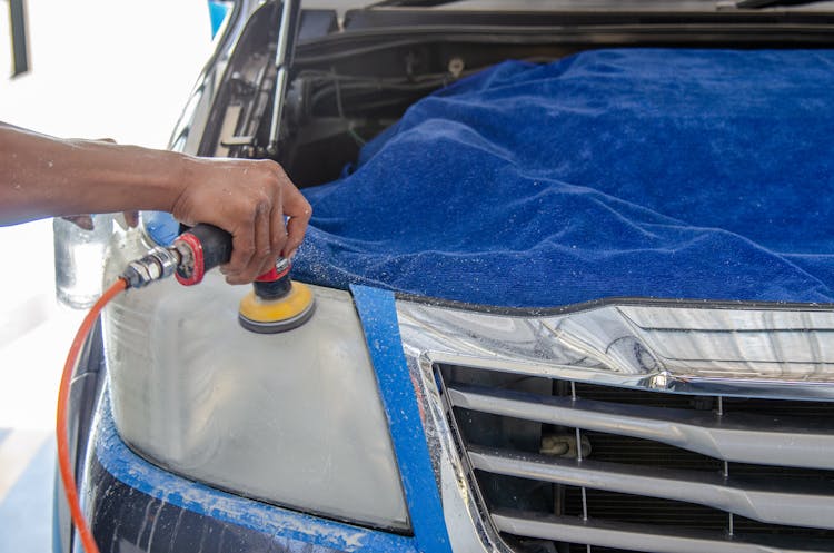  Person Using A Polishing Machine On The Car