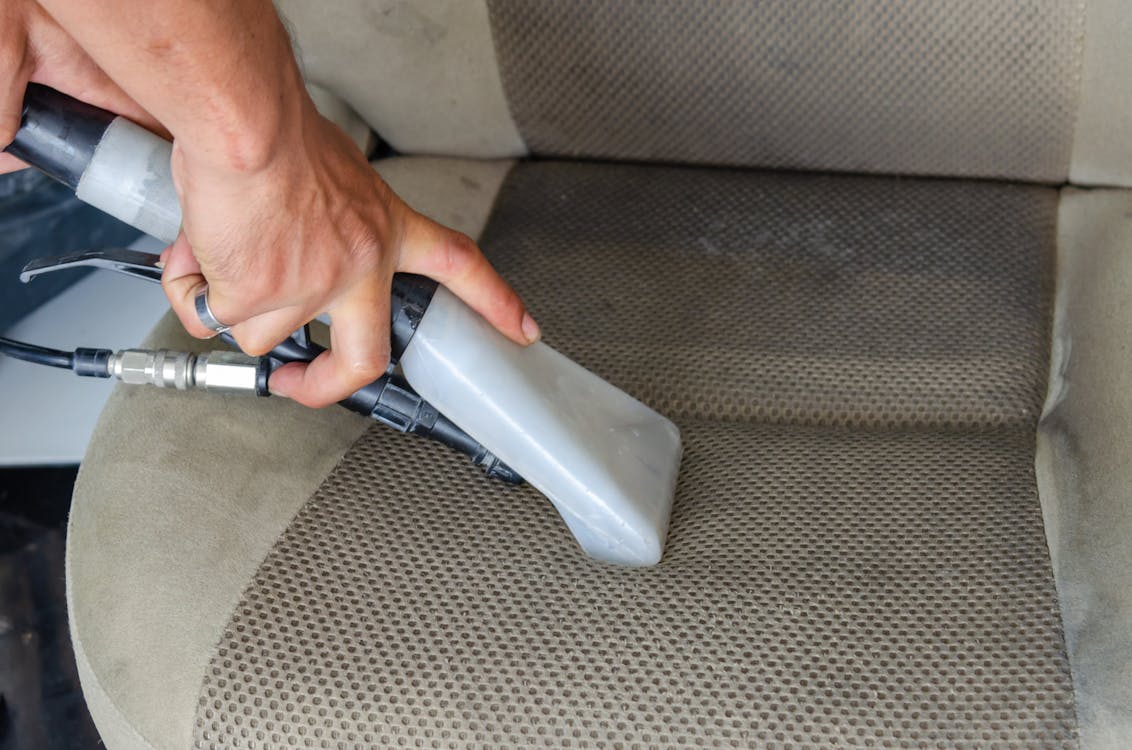 Free A Person Deep Cleaning a Car Seat Stock Photo