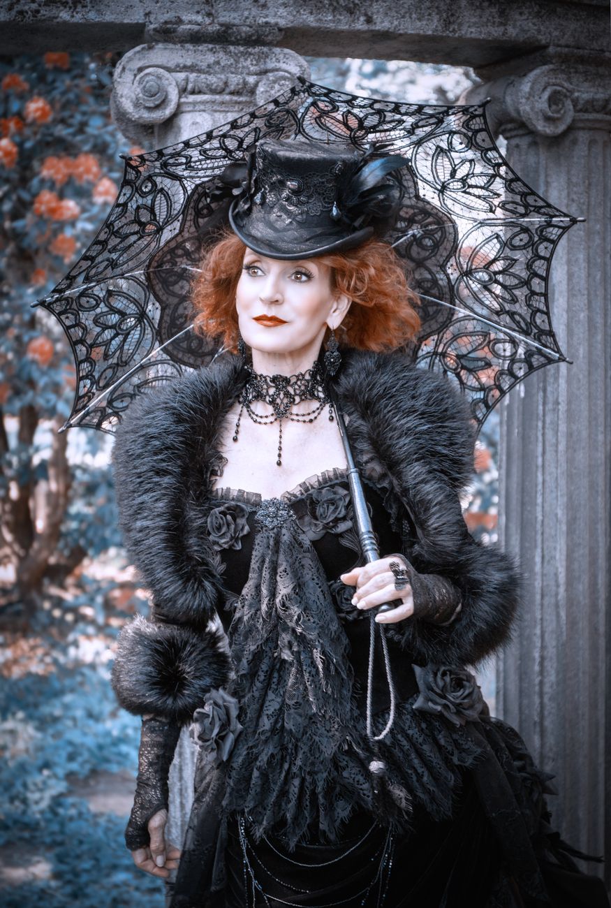 Striking portrait of a woman in gothic Victorian cosplay with a lace parasol in Leipzig.. pexels, striking, portrait