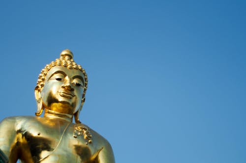 Golden Statue of a Buddha in Low Angle Shot