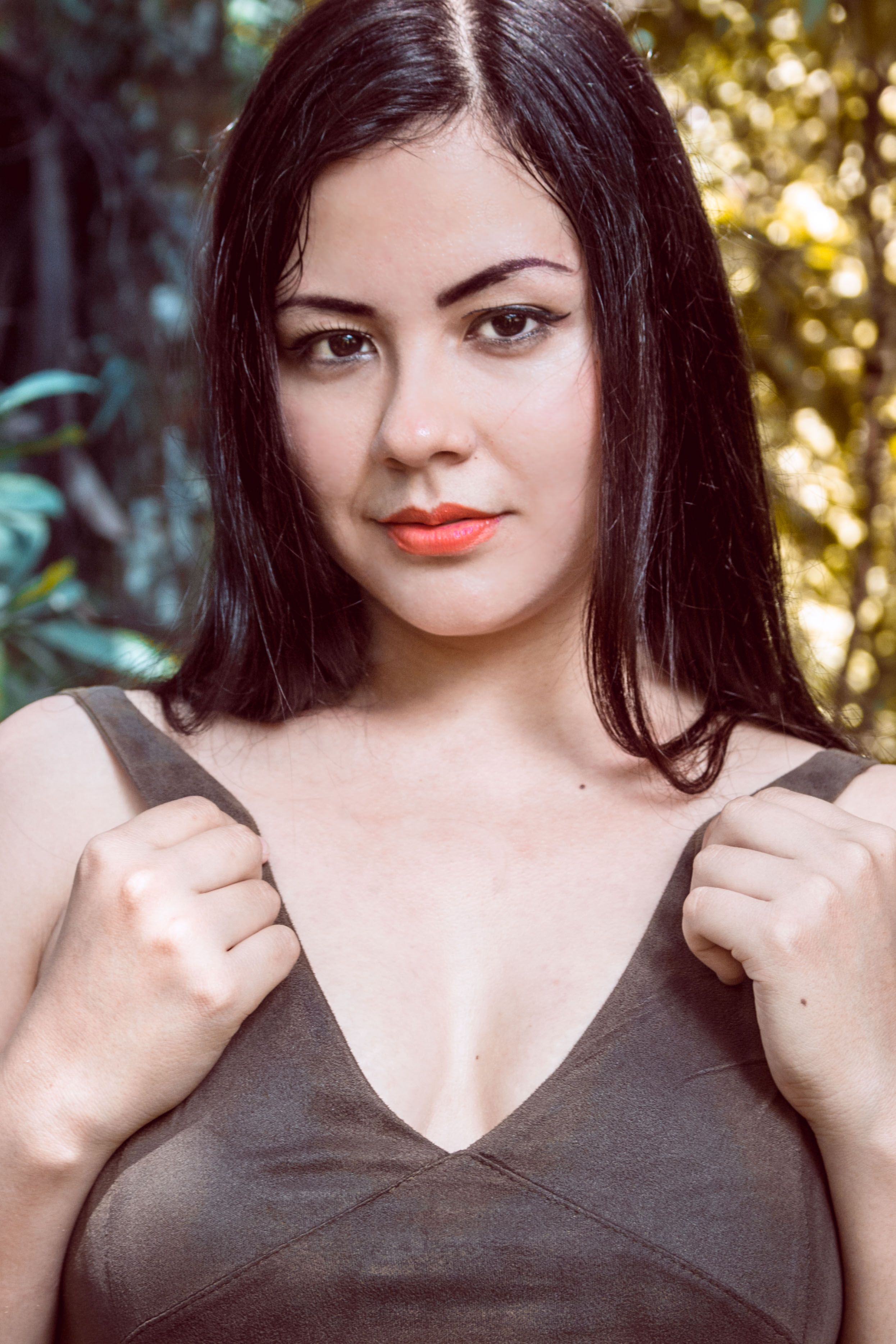 Close-up portrait of a young woman with black hair in a natural forest setting in Pucallpa, Peru.