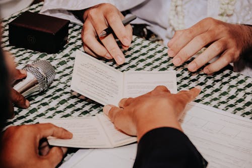 Free Hands Holding a Pen and Papers Stock Photo
