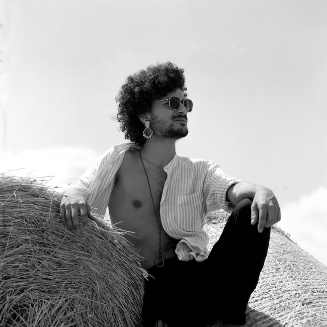 Stylish portrait of a man relaxing outdoors in Sicily, Italy.