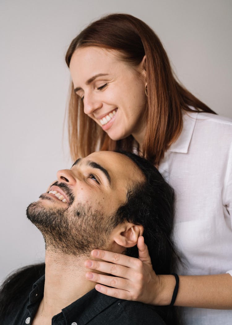 Woman Touching The Man's Neck