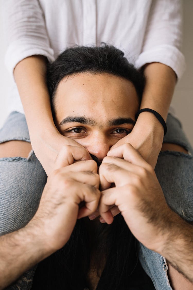 Person In White Shirt Covering The Face Of The Man 