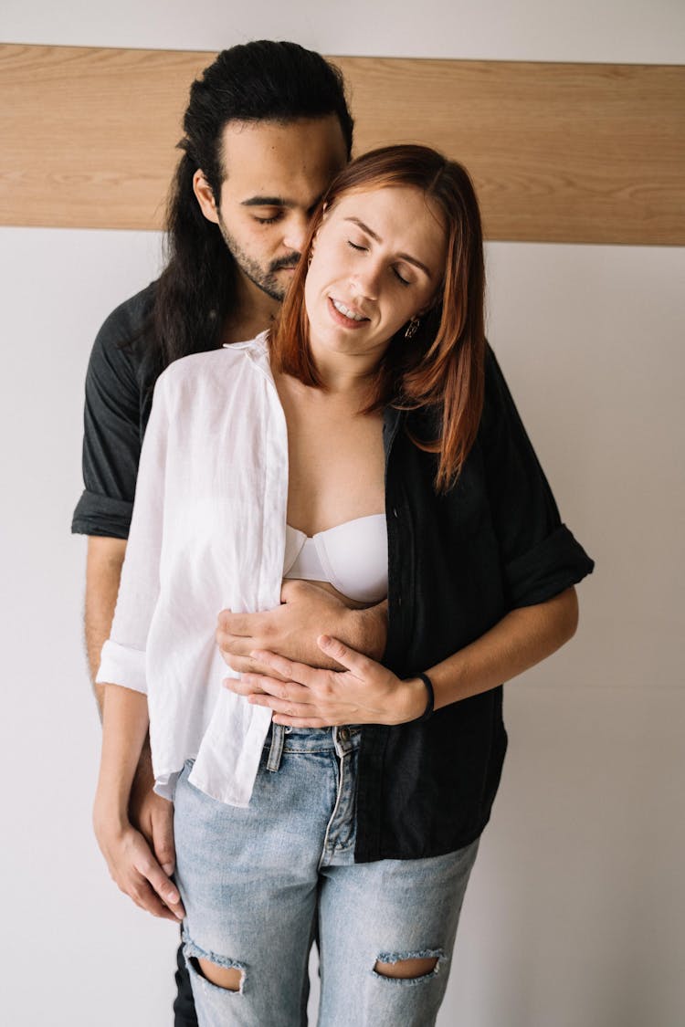 Man Hugging The Woman From Behind