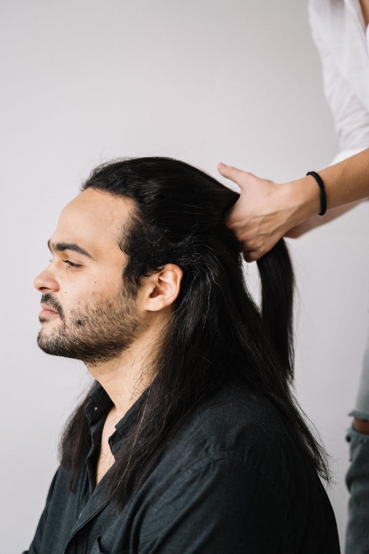 Person Parting The Bearded Man's Hair