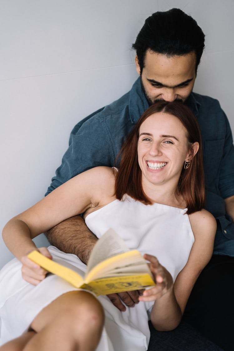 Man Kissing The Woman's Head