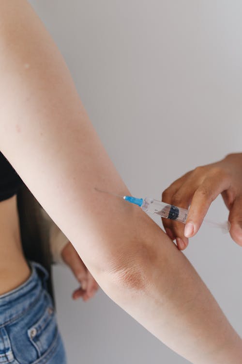 Free Hand Injecting Syringe on a Person Stock Photo