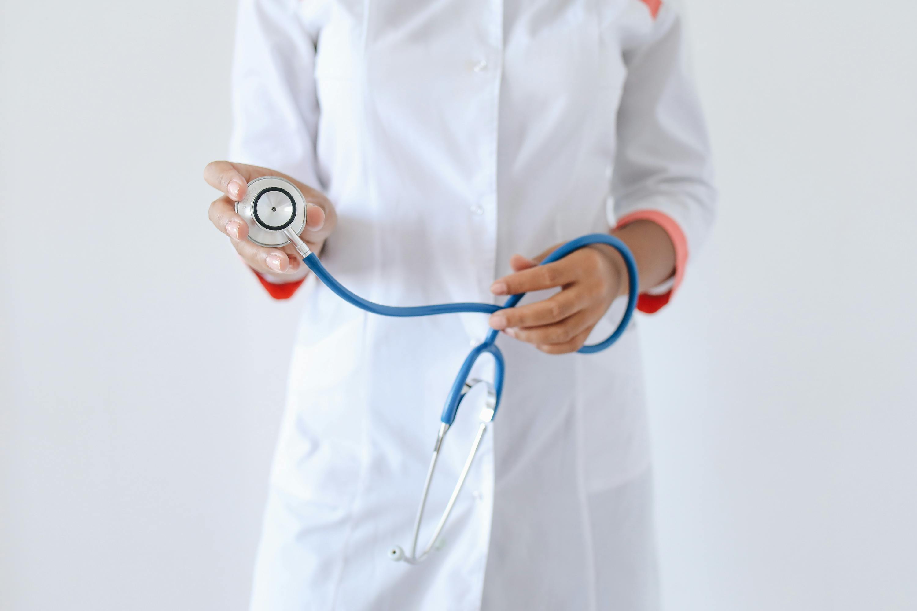 person holding a blue and silver stethoscope