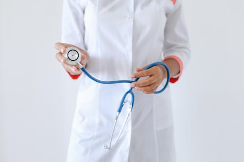 Person Holding a Blue and Silver Stethoscope