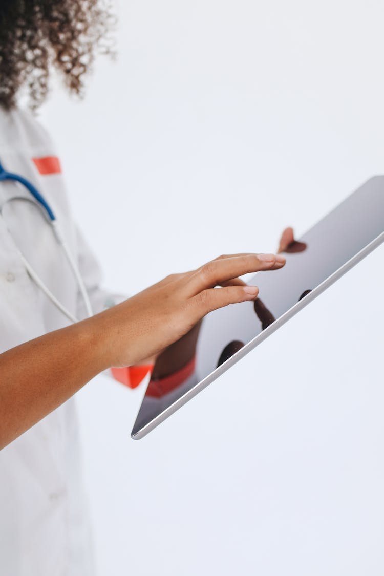 A Doctor Using A Tablet