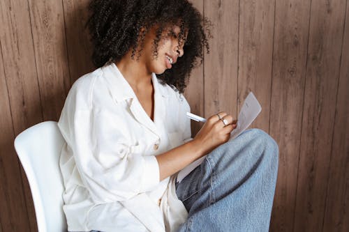 A Woman Writing on a Document