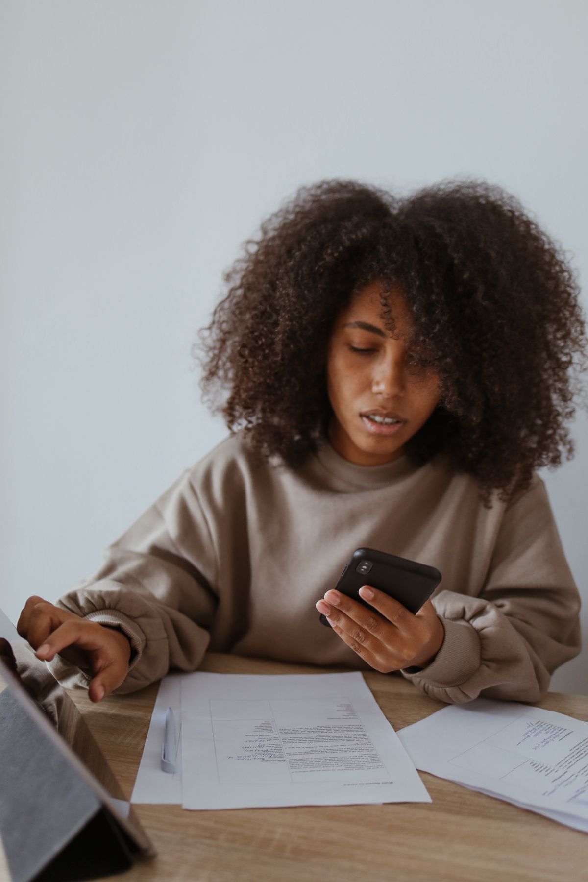 Mujer estudiando desde el celular en casa